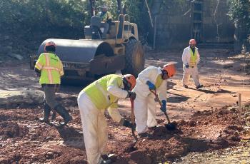 Compact Roller and workers working on the C & O Canal clay liner